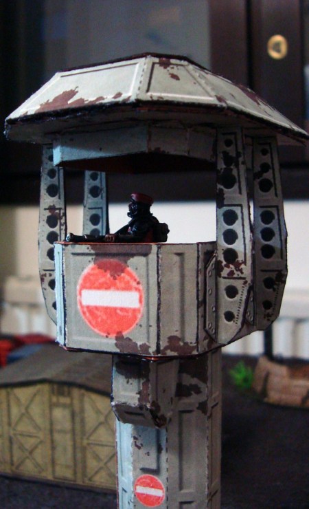 A guard scans the area with his LMG