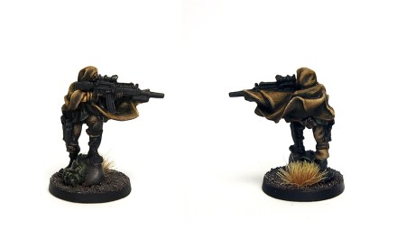 Photo of miniature with assault rifle, dressed in a cloak. Front and back views.