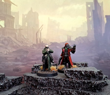Two miniatures posed against a science fiction background.
