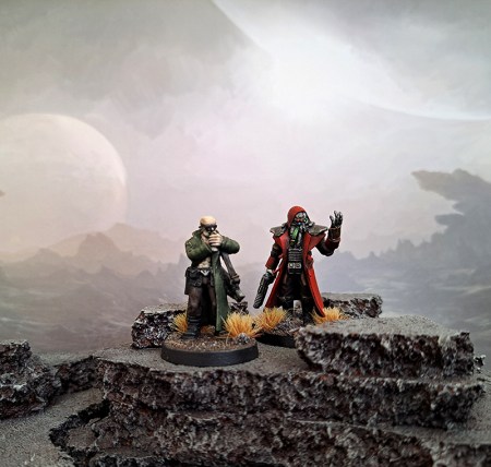 Two miniatures posed against a science fiction background.