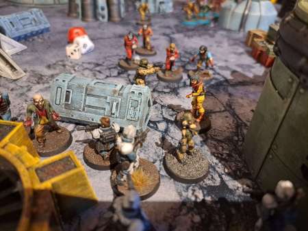 A close-up photo showing soldier miniatures surrounded by zombie miniatures in a science fiction setting