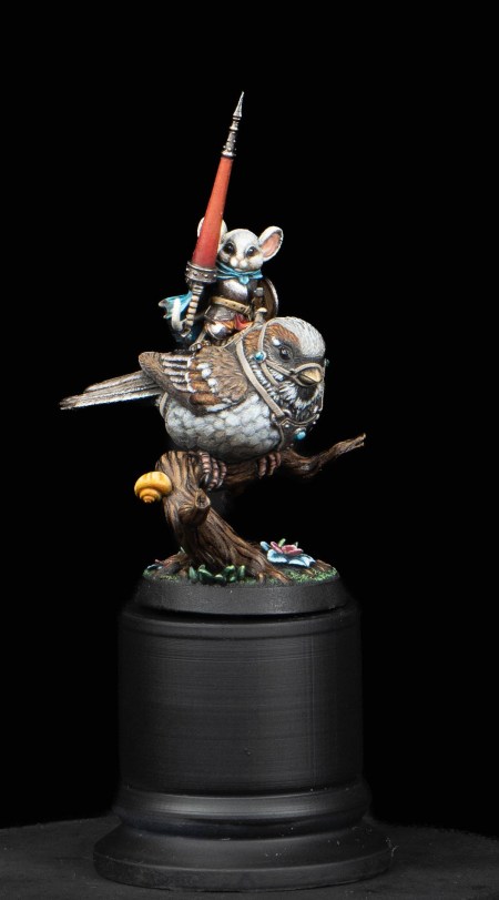 Photo of a painted miniature of a mouse knight riding a sparrow. 